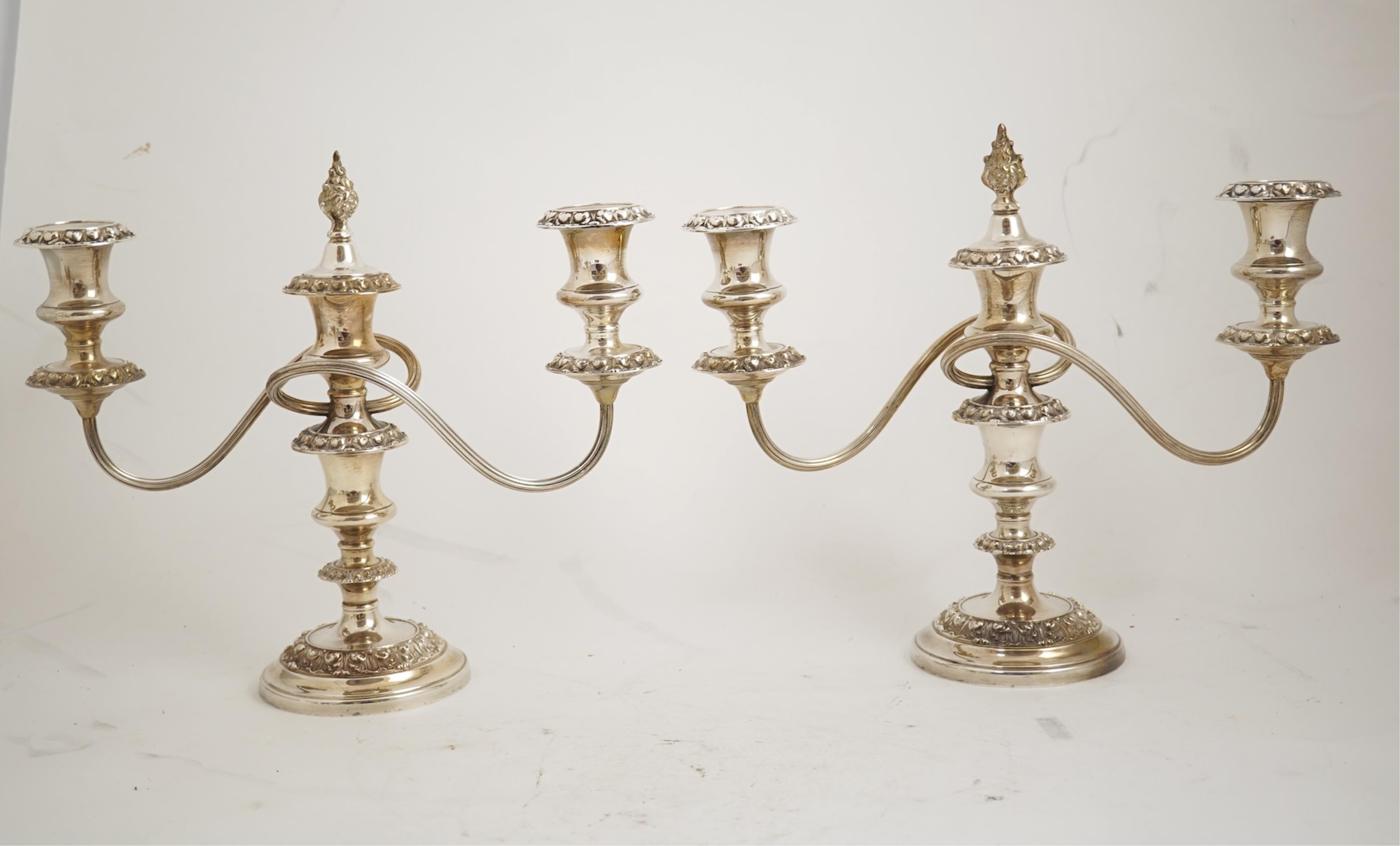 A pair of Elizabeth II silver dwarf two branch, three light candelabra by Barker Brothers Silver Co, with scroll arms and turned knopped stems, Birmingham, 1960, weighted, arms 52oz.